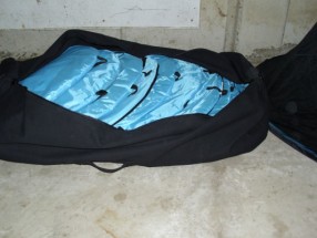 a dozen mosquito tents packed in a duffel bag